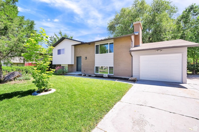 6034 S 2900 W, Roy, UT 84067 - raised ranch featuring a garage, driveway, brick siding, and a chimney