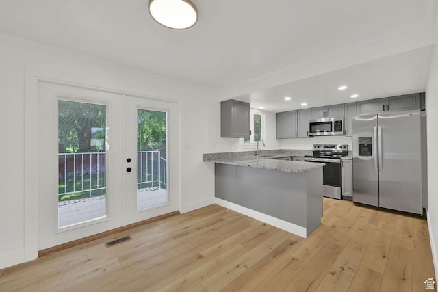 6034 S 2900 W, Roy, UT 84067 - kitchen with stainless steel appliances, gray cabinets, french doors, a peninsula, and light wood finished floors