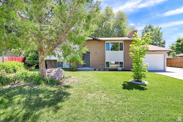 6034 S 2900 W, Roy, UT 84067 - view of front facade with concrete driveway, brick siding, a garage, and a chimney