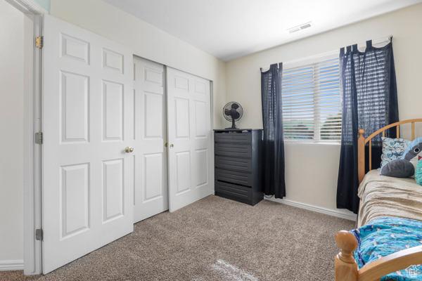 1405 N Durocher Ln W, Tooele, UT 84074 - bedroom featuring carpet floors, a closet, and baseboards