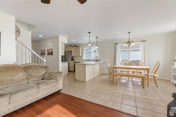 1405 N Durocher Ln W, Tooele, UT 84074 - living area featuring ceiling fan, a chandelier, stairway, light tile patterned floors, and baseboards