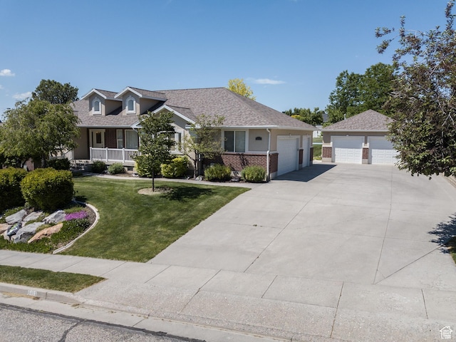 1655 E 3250 N, North Logan, UT 84341 - view of front of house featuring a front lawn, brick siding, and a detached garage
