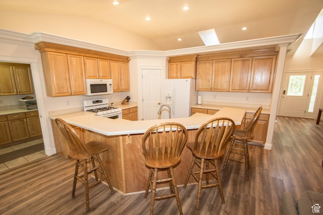 1655 E 3250 N, North Logan, UT 84341 - kitchen with white appliances, vaulted ceiling, a sink, dark wood-style flooring, and a kitchen breakfast bar