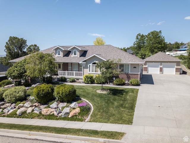 1655 E 3250 N, North Logan, UT 84341 - view of front of property featuring a front lawn, a garage, an outdoor structure, roof with shingles, and brick siding