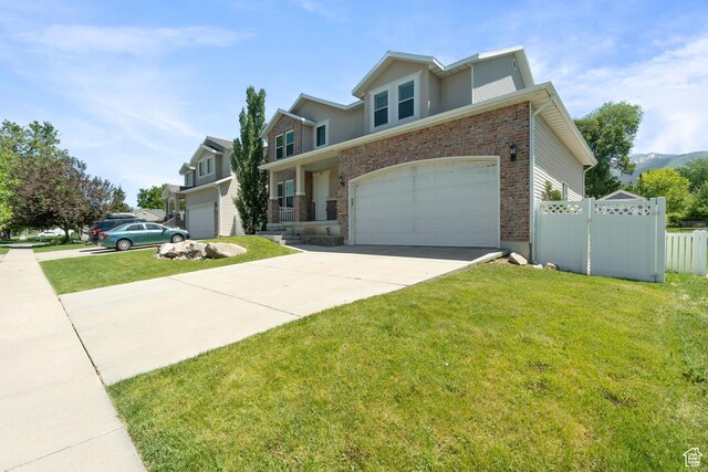 117 S 200 E, Kaysville, UT 84037 - traditional-style house with concrete driveway, brick siding, and an attached garage