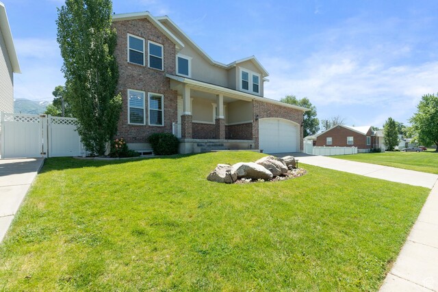 117 S 200 E, Kaysville, UT 84037 - view of front of house with driveway, brick siding, an attached garage, stucco siding, and a gate