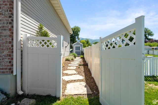 117 S 200 E, Kaysville, UT 84037 - view of property exterior featuring a gate, a mountain view, and brick siding