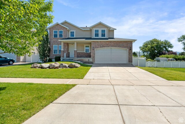 117 S 200 E, Kaysville, UT 84037 - traditional-style house featuring driveway, an attached garage, stucco siding, brick siding, and covered porch