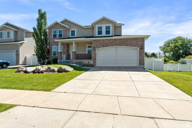 117 S 200 E, Kaysville, UT 84037 - view of front facade featuring driveway, an attached garage, stucco siding, brick siding, and a porch