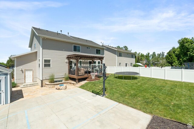 117 S 200 E, Kaysville, UT 84037 - back of property with a patio, a wooden deck, a trampoline, and a pergola