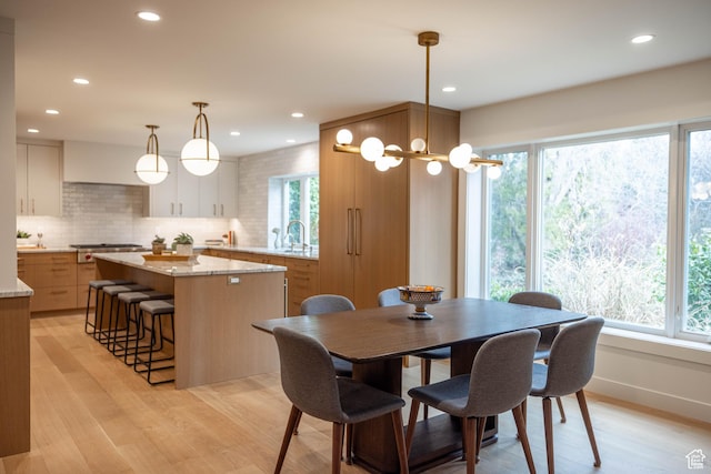 3563 S Canyon Way, Millcreek, UT 84106 - dining space with healthy amount of natural light, light wood finished floors, and recessed lighting