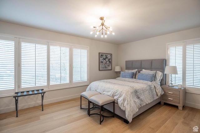 3563 S Canyon Way, Millcreek, UT 84106 - bedroom featuring a chandelier, light wood-style floors, and multiple windows