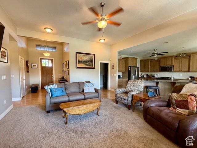 1523 E Talus Way, St George, UT 84790 - living area featuring a ceiling fan, light colored carpet, and baseboards