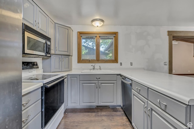 1236 E Violet Dr, Sandy, UT 84094 - kitchen featuring gray cabinets, stainless steel appliances, a sink, dark wood-style floors, and light countertops