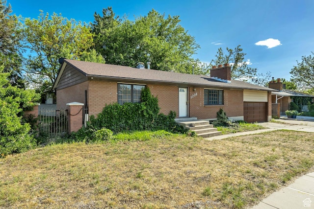 1236 E Violet Dr, Sandy, UT 84094 - single story home with brick siding, an attached garage, a chimney, and concrete driveway