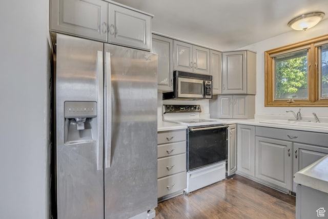 1236 E Violet Dr, Sandy, UT 84094 - kitchen featuring appliances with stainless steel finishes, gray cabinets, a sink, dark wood-style floors, and light countertops
