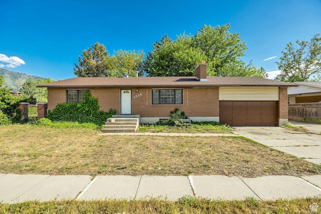 1236 E Violet Dr, Sandy, UT 84094 - ranch-style home featuring brick siding, an attached garage, concrete driveway, and a chimney