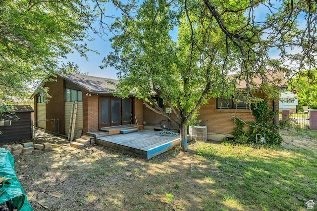 1236 E Violet Dr, Sandy, UT 84094 - back of property featuring brick siding, a deck, central AC, and a shingled roof