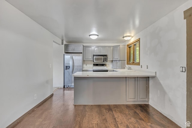 1236 E Violet Dr, Sandy, UT 84094 - kitchen featuring appliances with stainless steel finishes, gray cabinets, a peninsula, light countertops, and dark wood-style floors