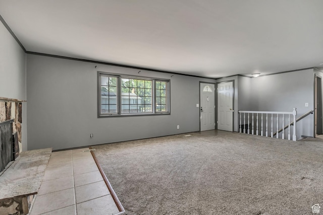 1236 E Violet Dr, Sandy, UT 84094 - unfurnished living room featuring ornamental molding, a fireplace with raised hearth, carpet floors, and tile patterned flooring