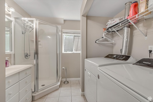 2316 E Claybourne Ave S, Millcreek, UT 84109 - bathroom featuring washing machine and dryer, a stall shower, tile patterned floors, vanity, and baseboards