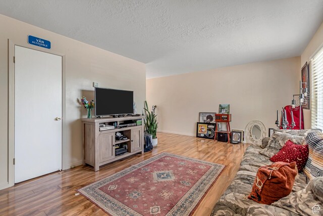 2316 E Claybourne Ave S, Millcreek, UT 84109 - living area with wood finished floors and a textured ceiling