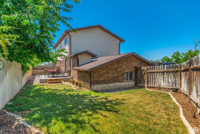 2316 E Claybourne Ave S, Millcreek, UT 84109 - back of property with brick siding, a wooden deck, and a shingled roof