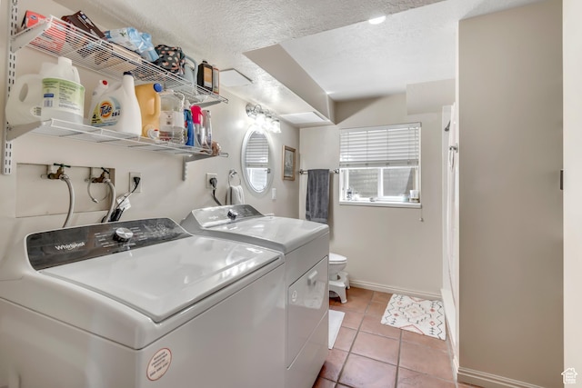 2316 E Claybourne Ave S, Millcreek, UT 84109 - washroom with washer and clothes dryer, baseboards, light tile patterned floors, and a textured ceiling