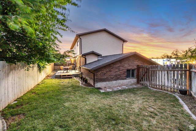 2316 E Claybourne Ave S, Millcreek, UT 84109 - property exterior at dusk with a wooden deck and a shingled roof