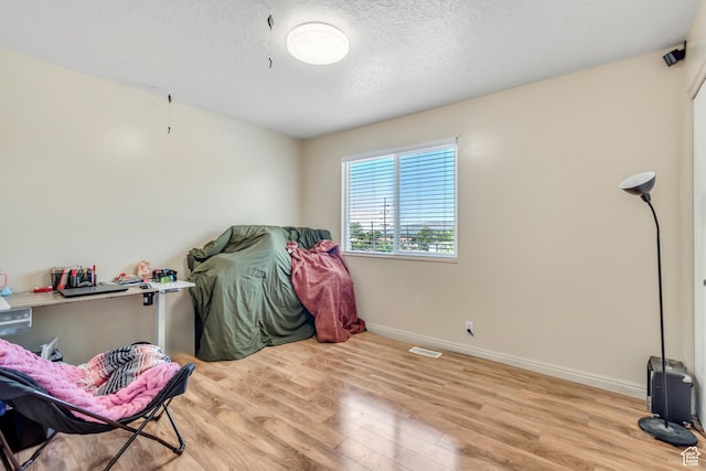 2316 E Claybourne Ave S, Millcreek, UT 84109 - misc room with wood finished floors, baseboards, and a textured ceiling