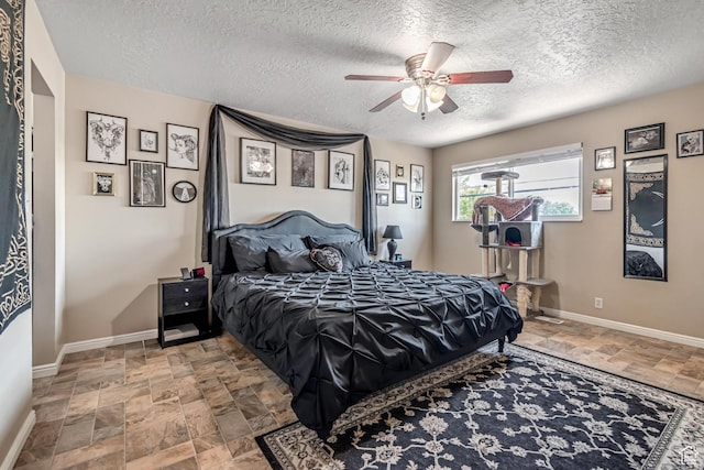 2316 E Claybourne Ave S, Millcreek, UT 84109 - bedroom with stone finish flooring, a textured ceiling, baseboards, and a ceiling fan