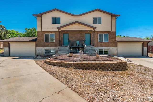 2316 E Claybourne Ave S, Millcreek, UT 84109 - view of front of property with concrete driveway, brick siding, a garage, and covered porch