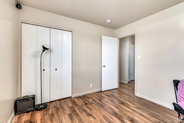 2316 E Claybourne Ave S, Millcreek, UT 84109 - unfurnished bedroom with wood finished floors, baseboards, and a closet
