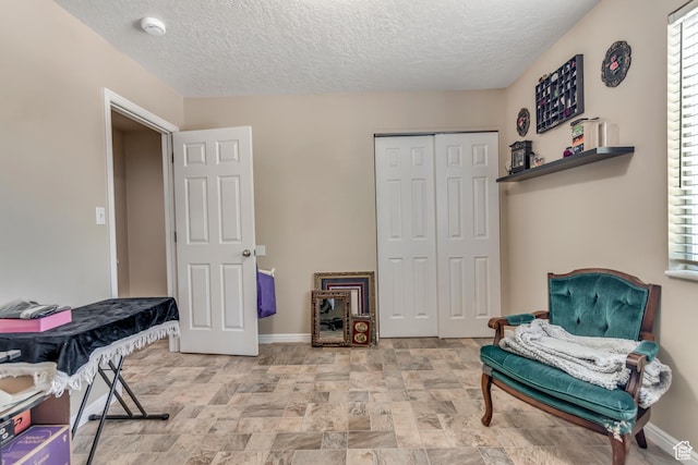 2316 E Claybourne Ave S, Millcreek, UT 84109 - living area with baseboards, a textured ceiling, and stone finish floors