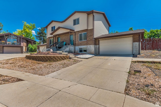 2316 E Claybourne Ave S, Millcreek, UT 84109 - view of front of property featuring brick siding, driveway, and an attached garage