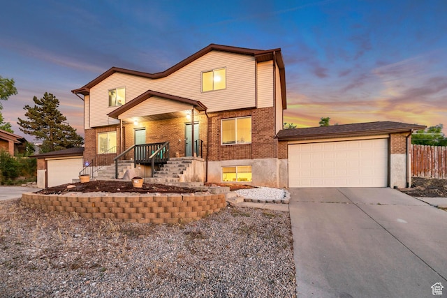 2316 E Claybourne Ave S, Millcreek, UT 84109 - view of front of property with brick siding, driveway, and an attached garage