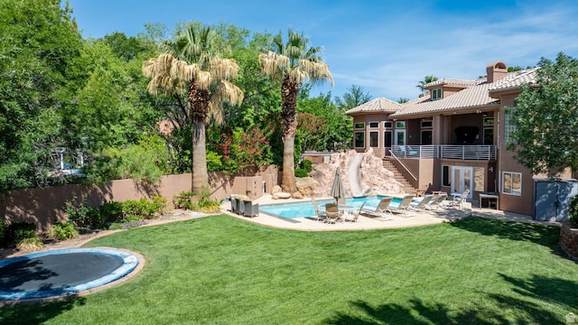 1287 W Bloomington Dr S Unit 7, Bloomington, UT 84790 - view of yard featuring stairs, a patio, a trampoline, a balcony, and french doors