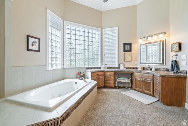 1287 W Bloomington Dr S Unit 7, Bloomington, UT 84790 - bathroom featuring vanity, a tub with jets, a wainscoted wall, and a ceiling fan