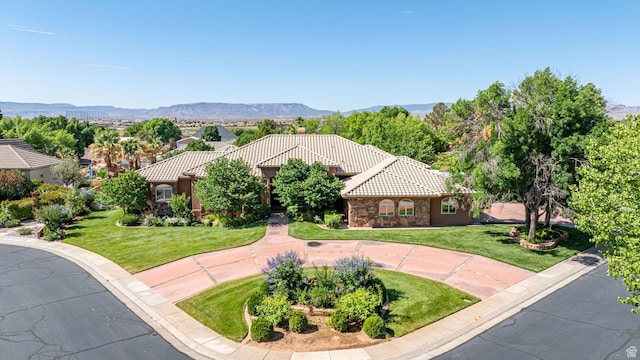 1287 W Bloomington Dr S Unit 7, Bloomington, UT 84790 - mediterranean / spanish-style home featuring a tiled roof, a front yard, stone siding, and a mountain view