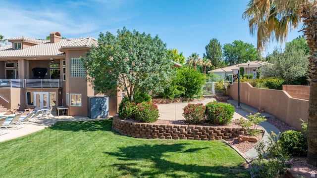 1287 W Bloomington Dr S Unit 7, Bloomington, UT 84790 - view of yard with french doors, a patio area, and a balcony