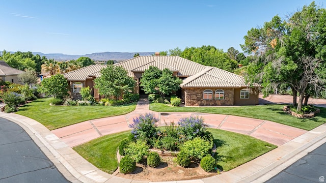 1287 W Bloomington Dr S Unit 7, Bloomington, UT 84790 - mediterranean / spanish home with a tile roof, a front lawn, stone siding, and stucco siding