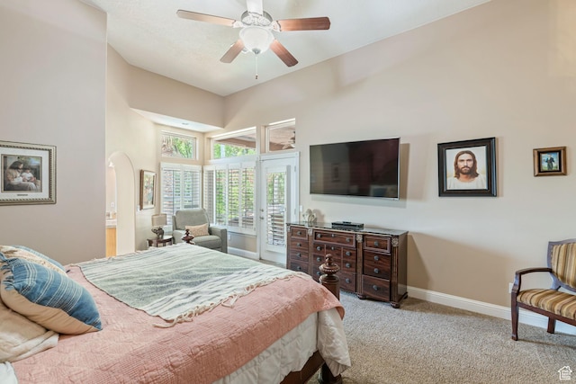 1287 W Bloomington Dr S Unit 7, Bloomington, UT 84790 - carpeted bedroom featuring access to outside, arched walkways, a ceiling fan, and a high ceiling