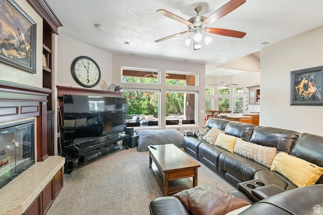 1287 W Bloomington Dr S Unit 7, Bloomington, UT 84790 - living area with a ceiling fan, carpet, a glass covered fireplace, and a textured ceiling