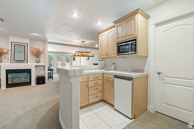 1287 W Bloomington Dr S Unit 7, Bloomington, UT 84790 - kitchen featuring light brown cabinetry, stainless steel microwave, dishwasher, open floor plan, and tile countertops