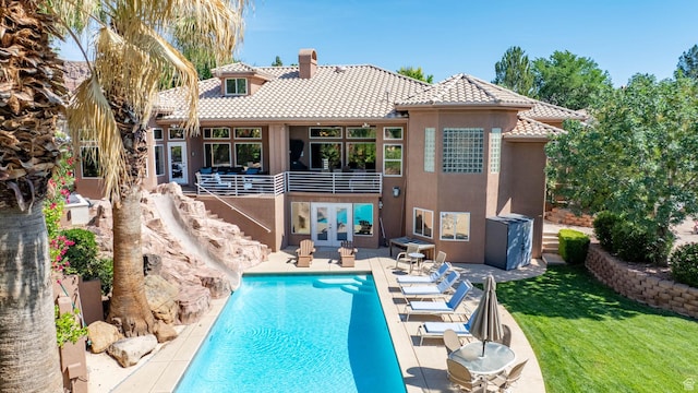 1287 W Bloomington Dr S Unit 7, Bloomington, UT 84790 - rear view of house featuring a tile roof, french doors, stucco siding, an outdoor pool, and a chimney