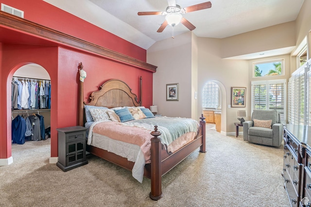 1287 W Bloomington Dr S Unit 7, Bloomington, UT 84790 - carpeted bedroom featuring a walk in closet, ceiling fan, a closet, high vaulted ceiling, and arched walkways