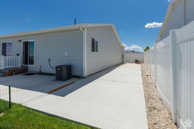 1142 W Honeycomb Dr, Grantsville, UT 84029 - view of side of property with central AC, a patio area, and a fenced backyard