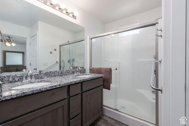 1142 W Honeycomb Dr, Grantsville, UT 84029 - full bath with wood finished floors, a shower stall, double vanity, and a ceiling fan