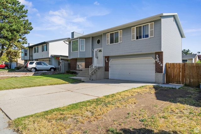 4924 W Barton Park Dr, West Jordan, UT 84081 - bi-level home with brick siding, a garage, driveway, and a chimney