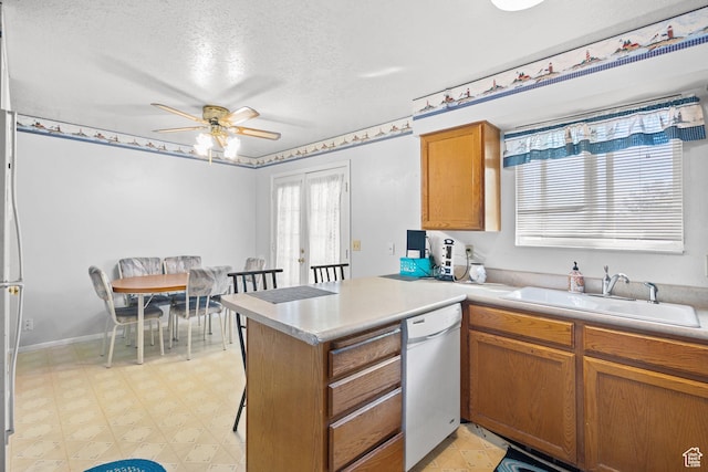 4924 W Barton Park Dr, West Jordan, UT 84081 - kitchen featuring white dishwasher, a peninsula, ceiling fan, light flooring, and a textured ceiling